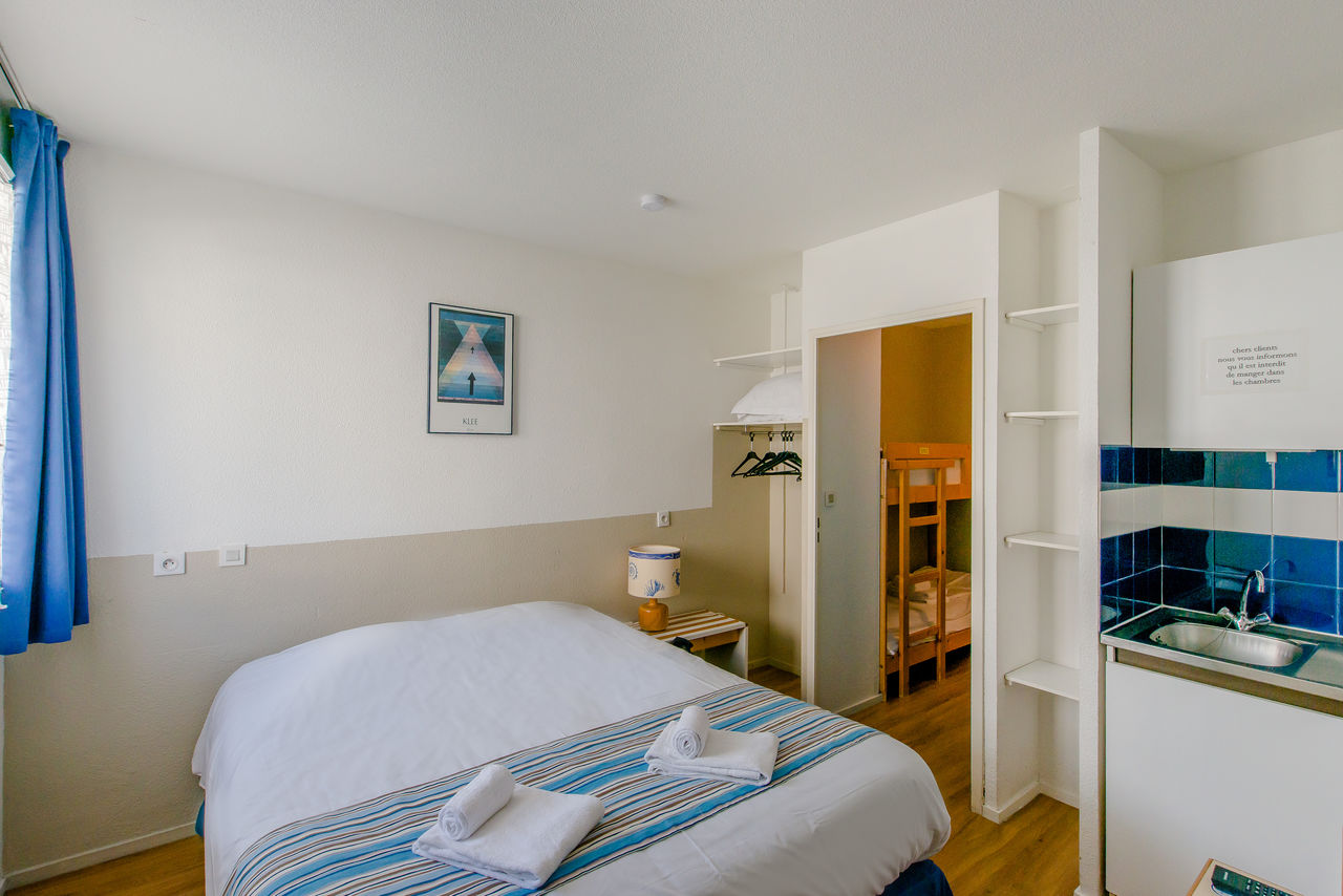 Schlafzimmer mit Doppelbett, Kochnische, Etagenbetten im CAPFUN H�tel/R�sidence Oc�ane in Andernos.