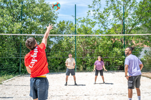 Volleyball players on sand court at CAPFUN Arbois du Castellet campsite in LE CASTELLET (83).