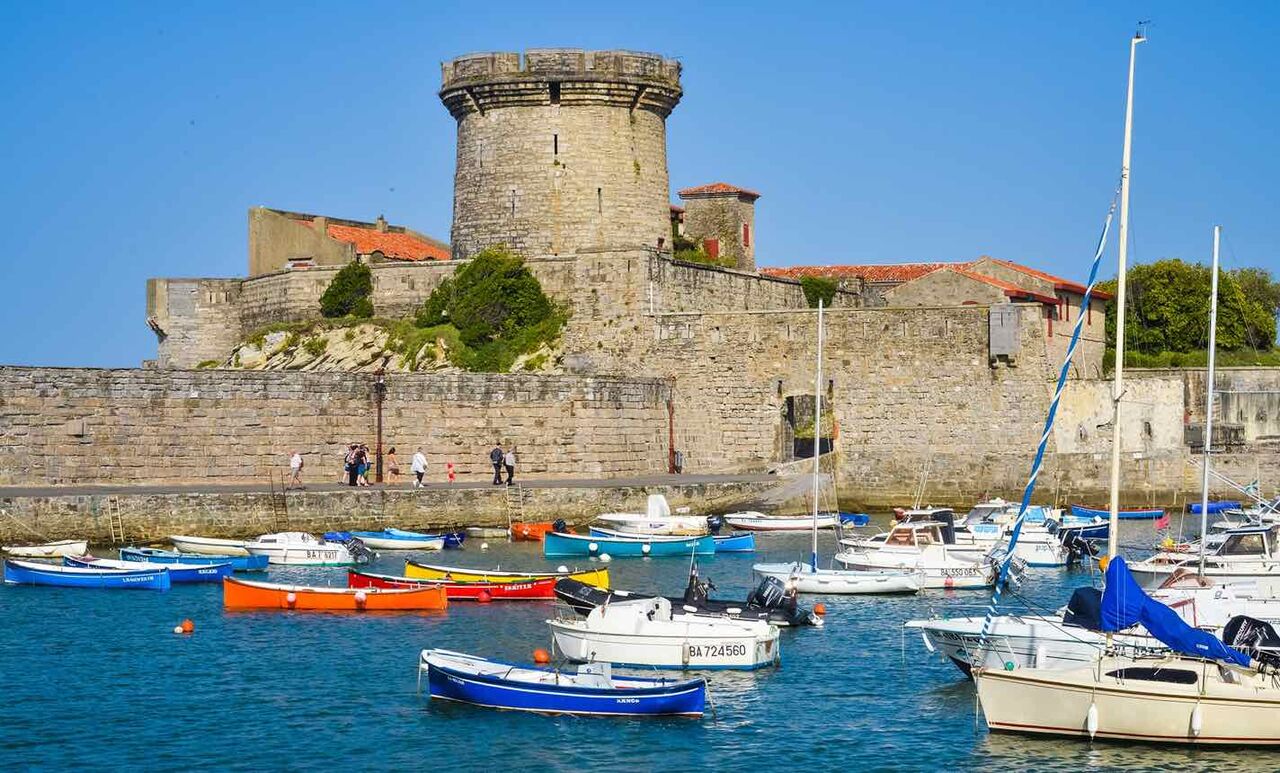 Colorful marina and historic fortified town, a must-visit in Nouvelle-Aquitaine.