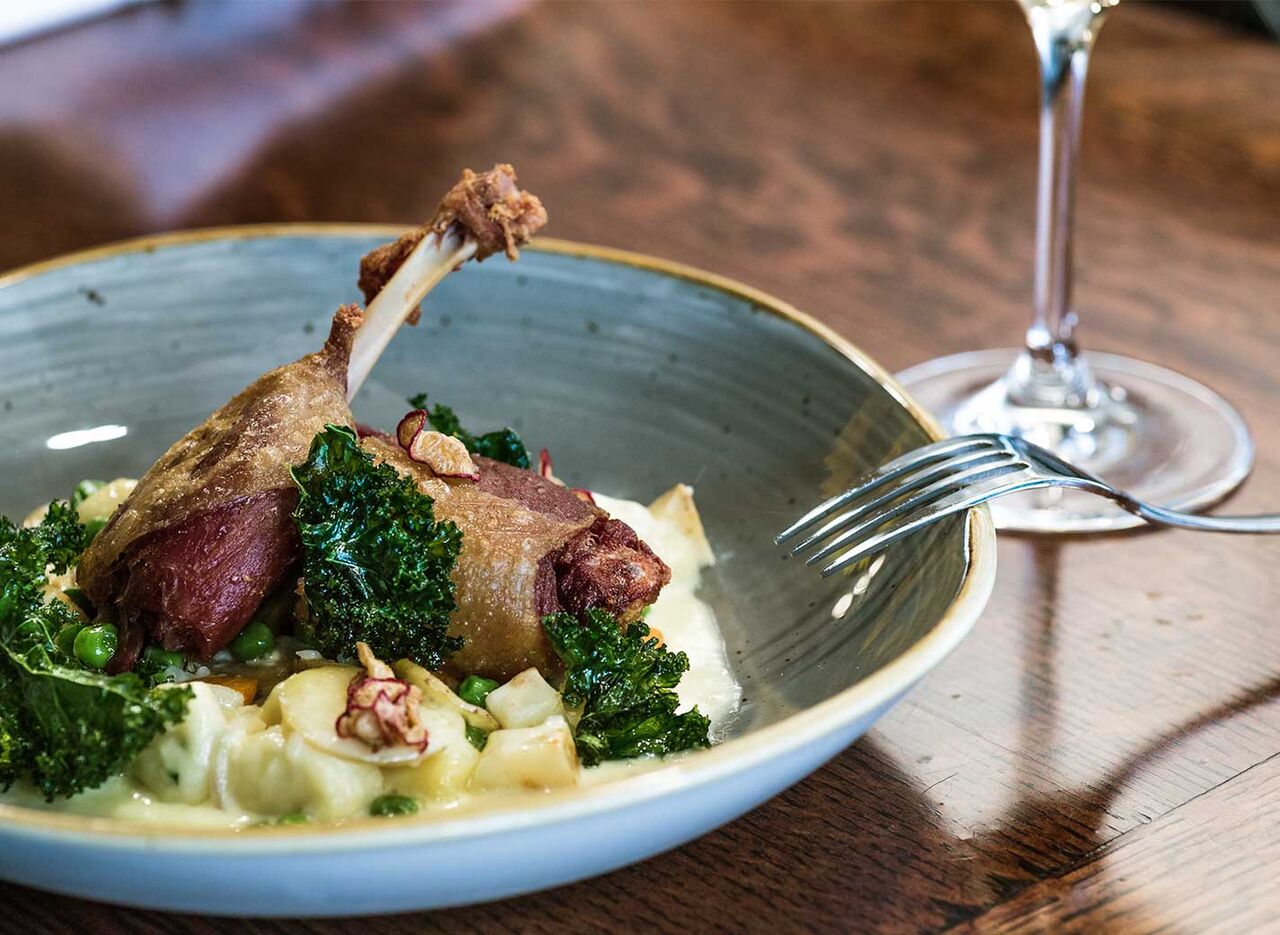 Duck confit with vegetables and creamy sauce at the restaurant of camping LIBRANOO Naturiste Arnaoutchot in Veille-Saint-Girons, Landes, France.