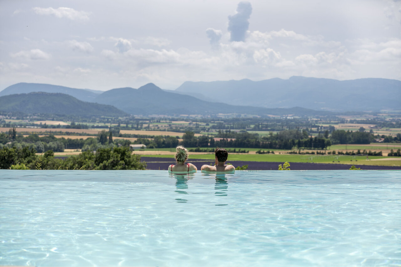 Infinity pool, couple, panoramic view at CLICOCHIC Bastets campsite in Marsanne.