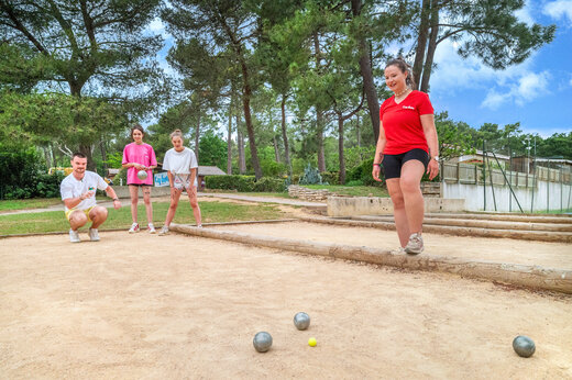 Petanque court and players at CAPFUN Beauregard campsite in MORNAS (84).