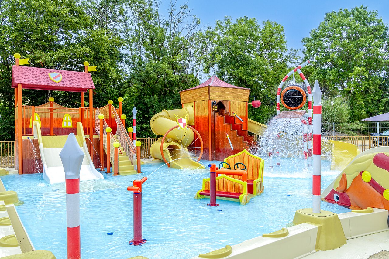 Water play area with slides at CLICOCHIC Beau Rivage campsite in LA ROQUE-GAGEAC.