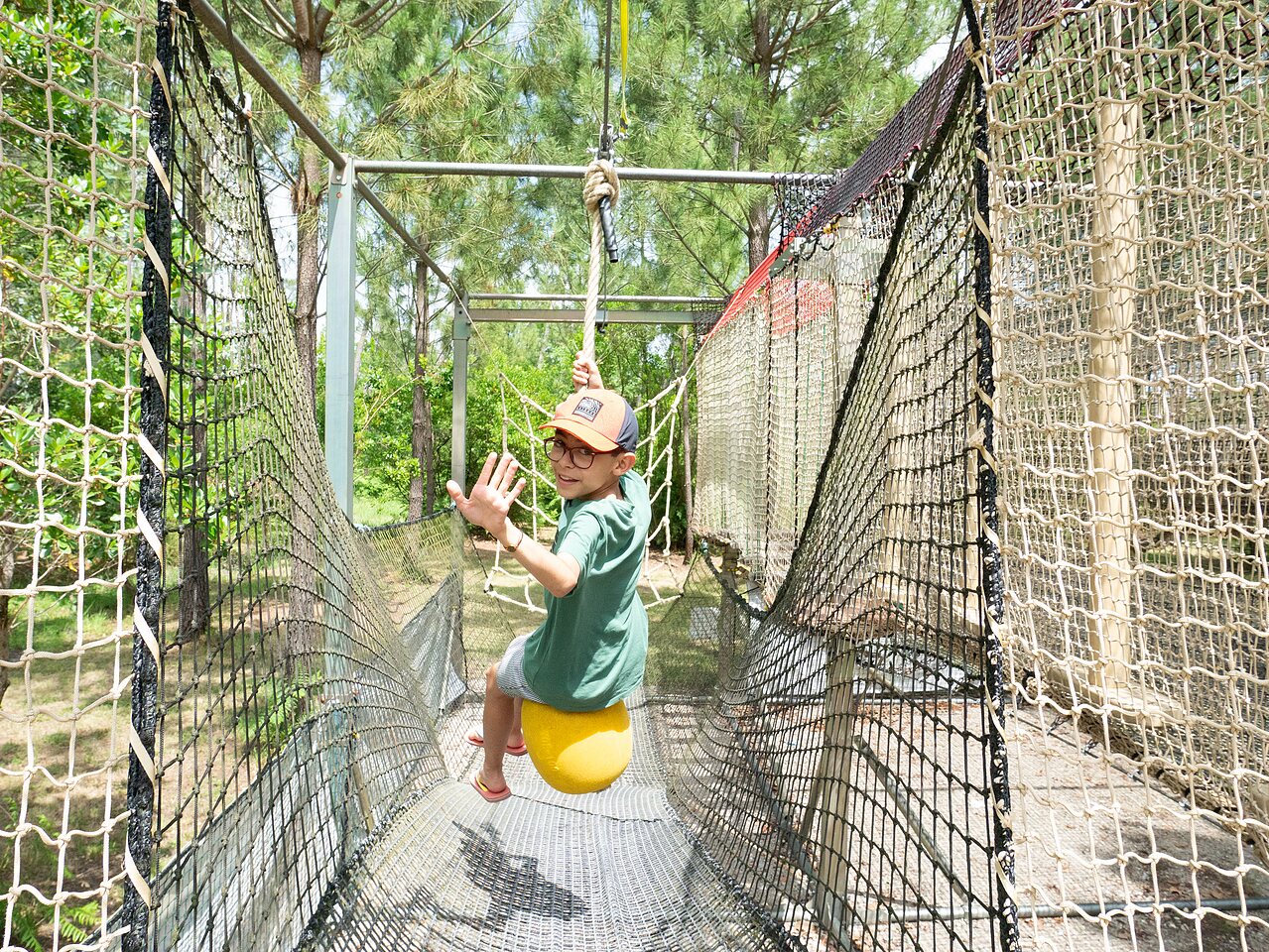 Child on net swing in adventure park, CLICOCHIC Bimbo in BISCARROSSE (40).