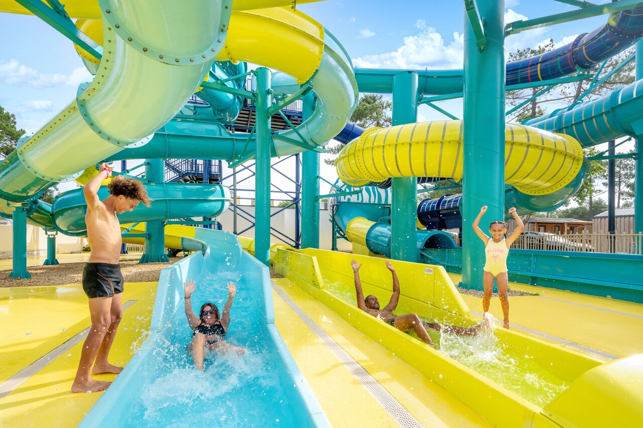 Colorful water slides and children having fun at camping VAGUES OCEANES Boudigau in LABENNE OCEAN (40).