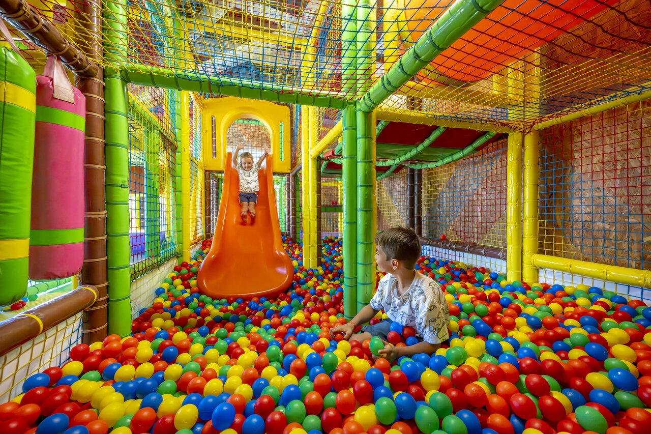 Playground, slide, ball pit at VAGUES OCEANES Boudigau campsite.