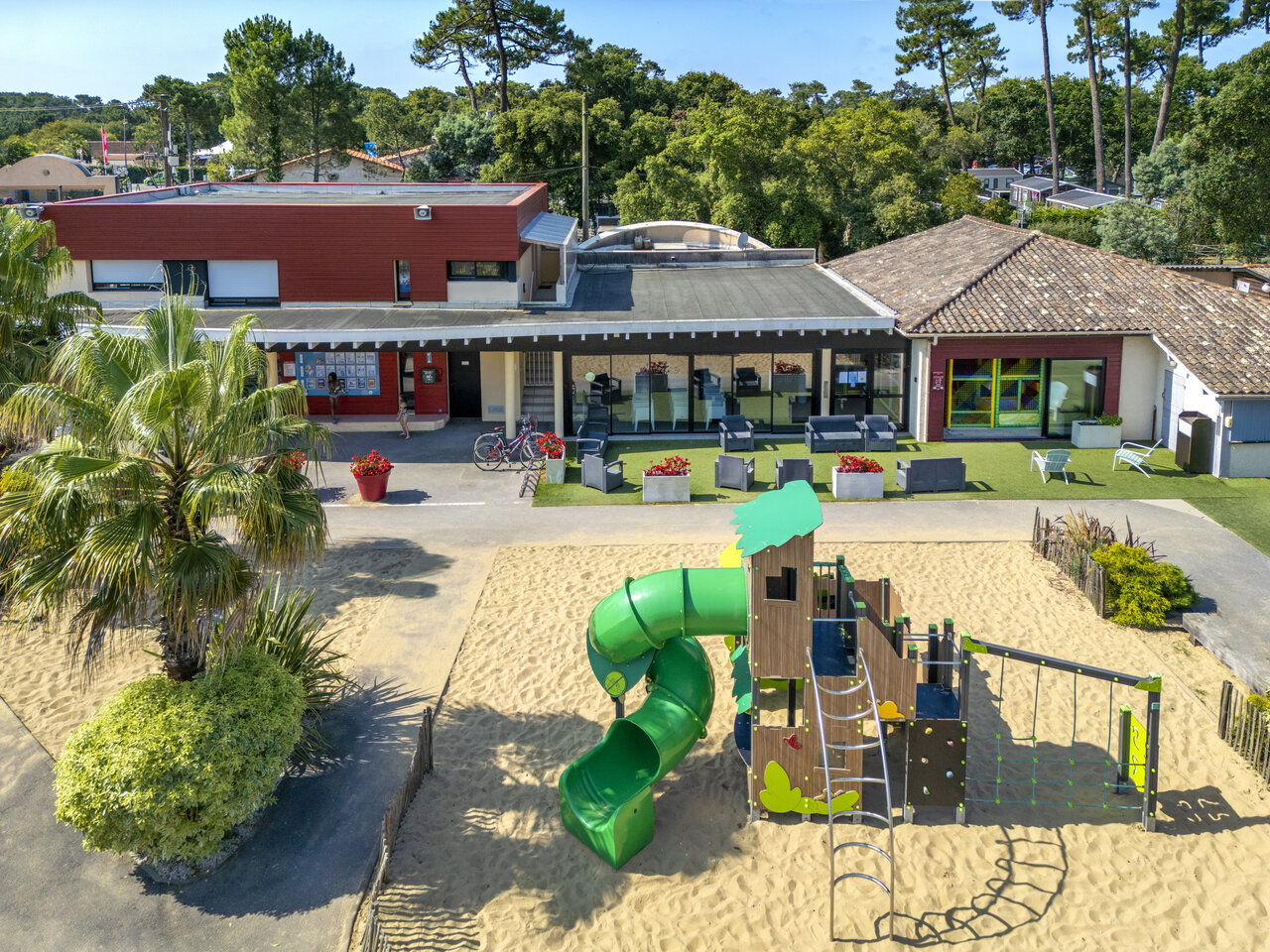 Playground, slide, main buildings of VAGUES OCEANES Boudigau campsite LABENNE OCEAN (40).