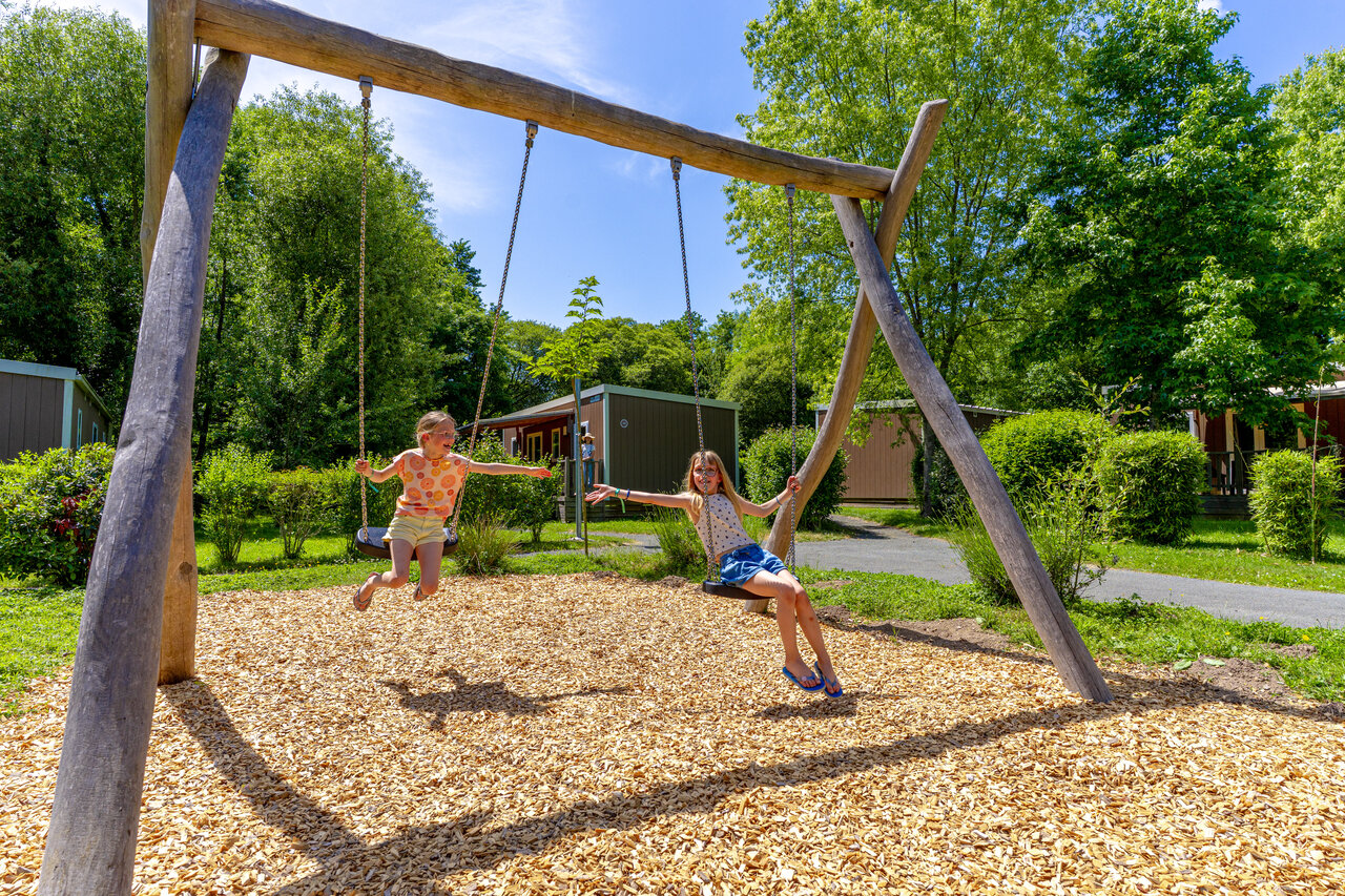 Spielplatz mit Kindern auf Schaukeln auf dem Campingplatz CAPFUN Breteche in Les Epesses (85).