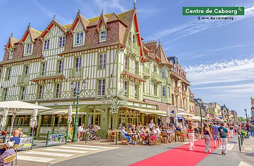 Lively city center of Cabourg with typical buildings and cafe terraces.