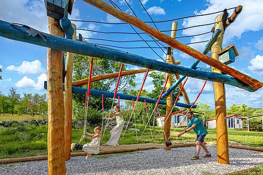 Holzspielplatzstruktur und Seilschaukel auf dem Campingplatz CLICOCHIC Castillon de Provence.