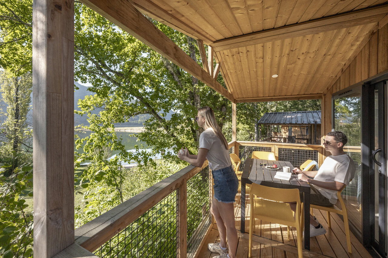 Accommodation terrace with lake view at camping CLICOCHIC Chancia in Chancia (01).