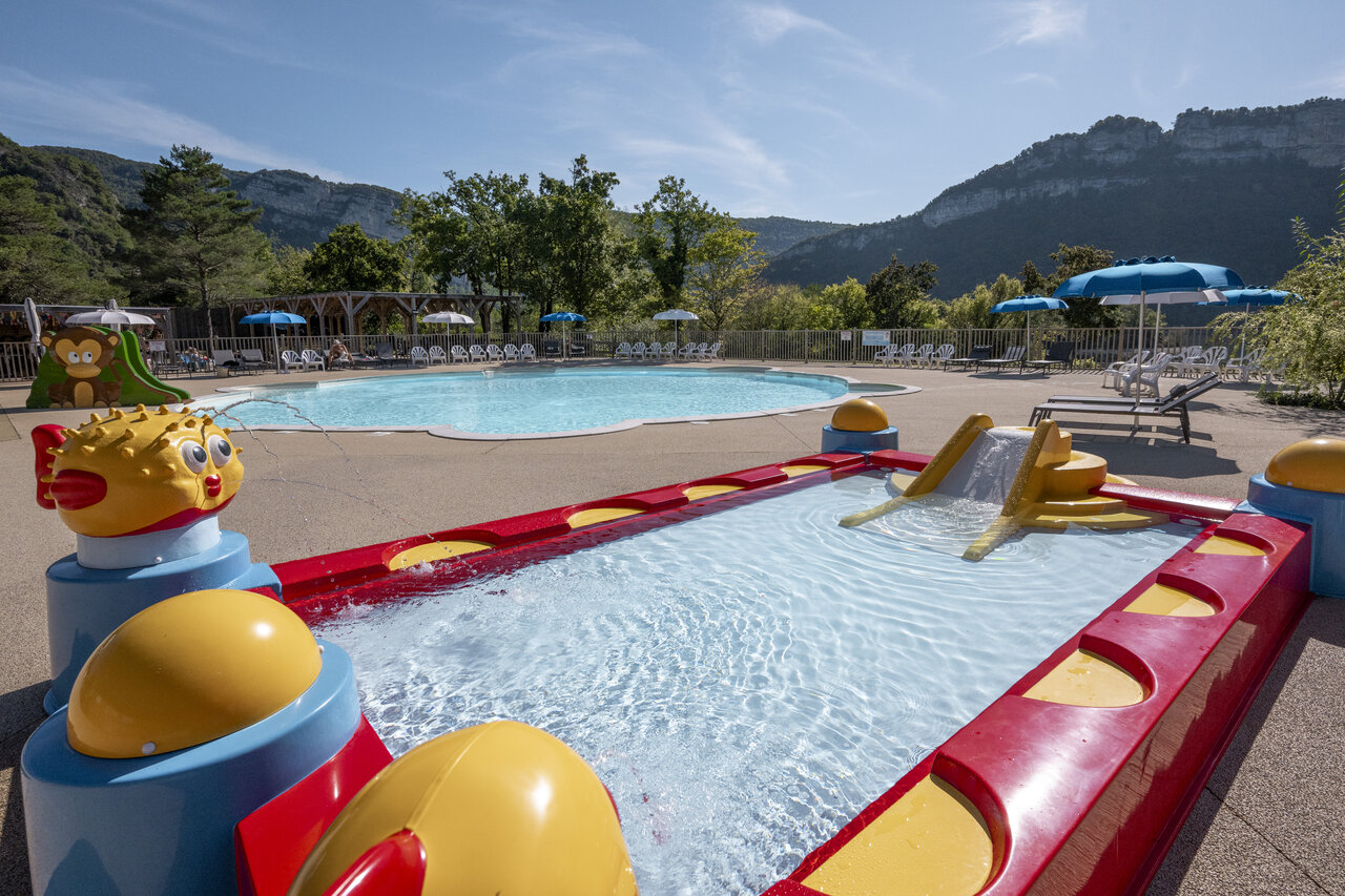 Outdoor swimming pool, splash pad with slide and water games at CLICOCHIC Chancia campsite in Chancia (01).