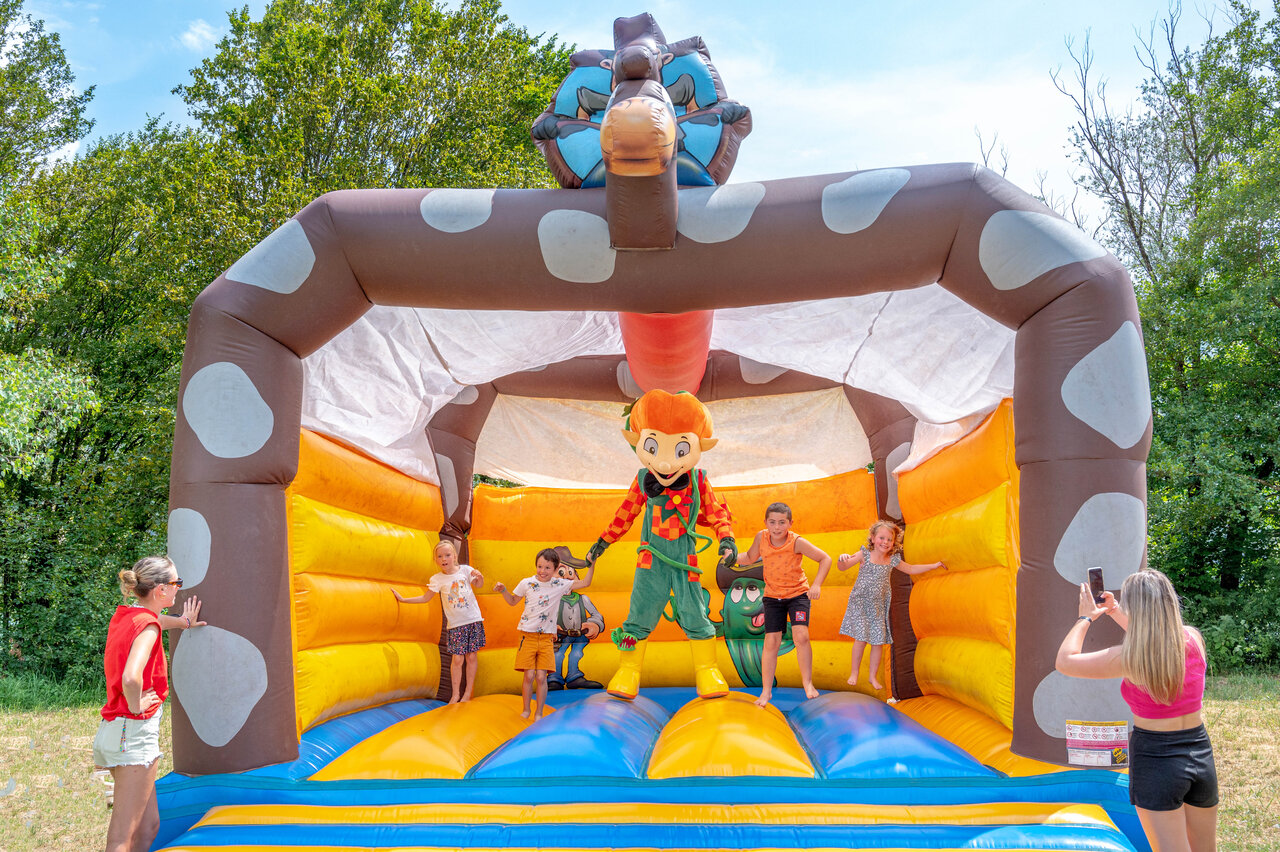 Bouncy castle with children and mascot at CLICOCHIC Chancia campsite in Chancia (01).