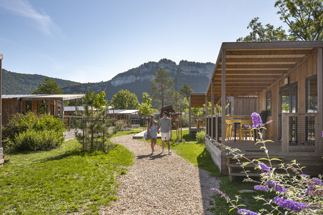 Wooden mobile homes, couple walking, nature at CLICOCHIC Chancia campsite (01).