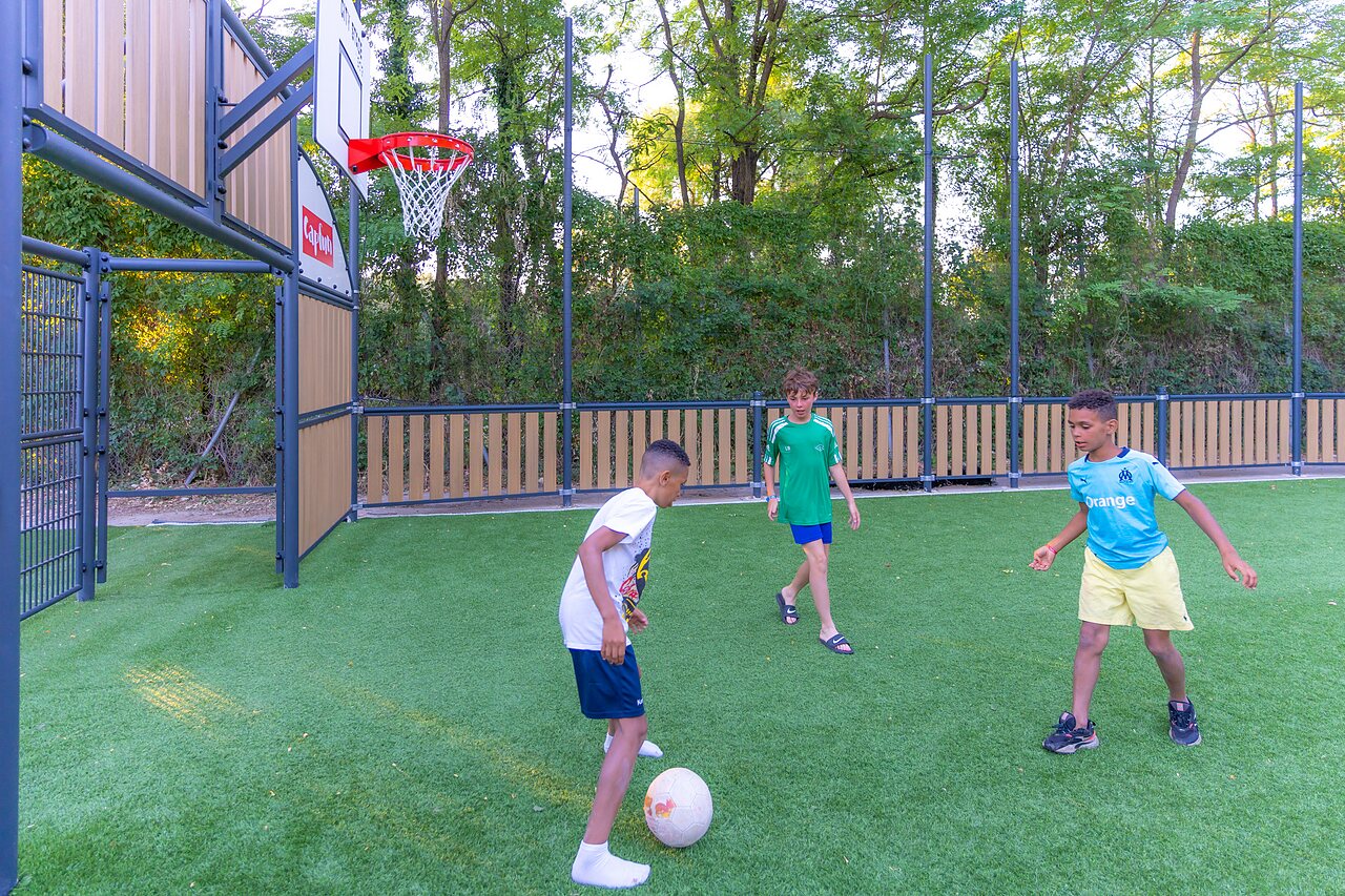 Terrain multisport enfants jouant au camping CLICOCHIC Ch�teau de Boisson � All�gre-les-Fumades.