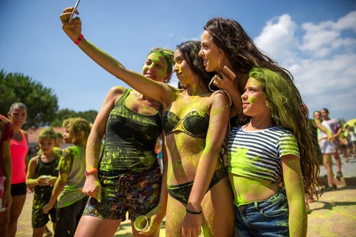Animation fête des couleurs, groupe souriant prenant un selfie au camping CAPFUN Chateau d'Arvid.