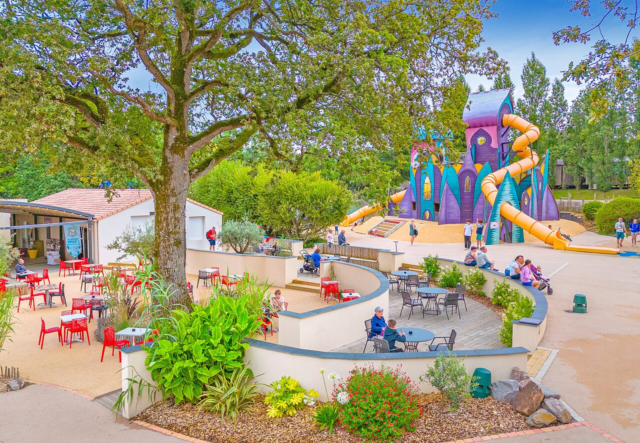 Groot kasteel speelterrein met glijbanen en terras op camping CAPFUN La Ch�naie in PORNIC (44).