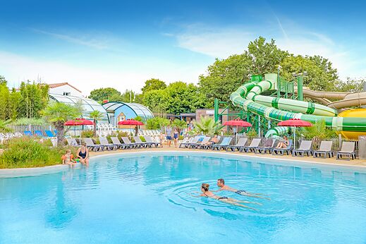 Außenpool, riesige Wasserrutschen und Stühle auf Camping CAPFUN La Chênaie PORNIC (44).