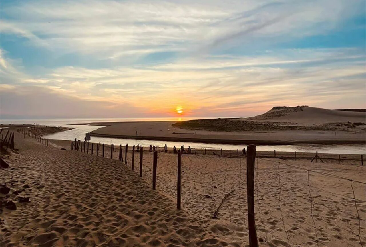 Sunset over beach, estuary and dunes at VAGUES OCEANES Les Cigales campsite in Moliets-Plage (40).