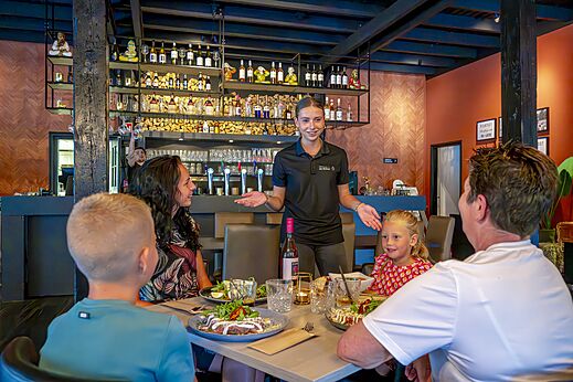 Familie speist im Restaurant mit Service auf Campingplatz CAPFUN De Belten in Rheeze.