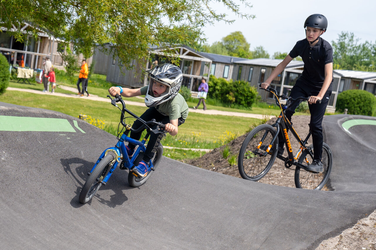 Kinder auf dem Pumptrack des Campingplatzes CAPFUN De Bongerd in Tuitjenhorn.