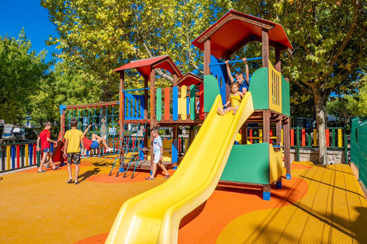 Parque infantil colorido, tobog�n y ni�os en el camping CAPFUN El Escorial, Madrid.