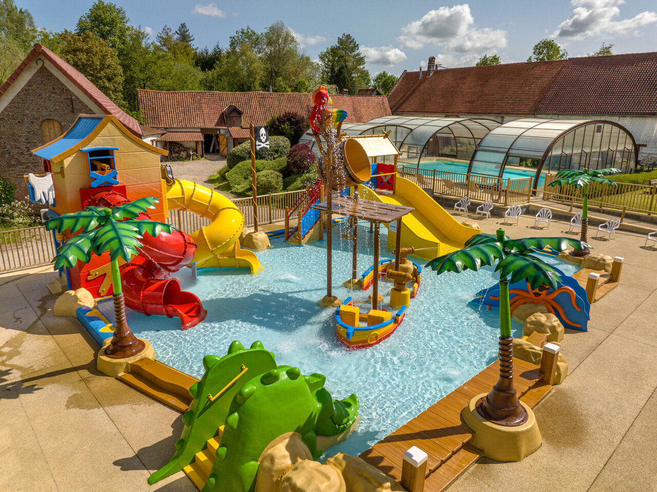Fun water play area, slides, pirate ship at CLICOCHIC Ferme des Aulnes campsite.