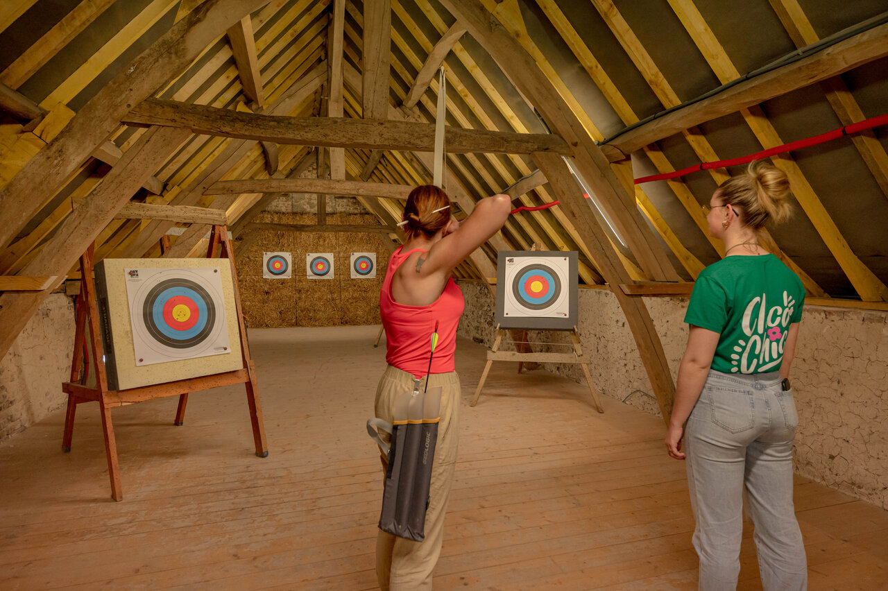 Archery activity indoors at CLICOCHIC Ferme des Aulnes campsite in NAMPONT SAINT MARTIN.