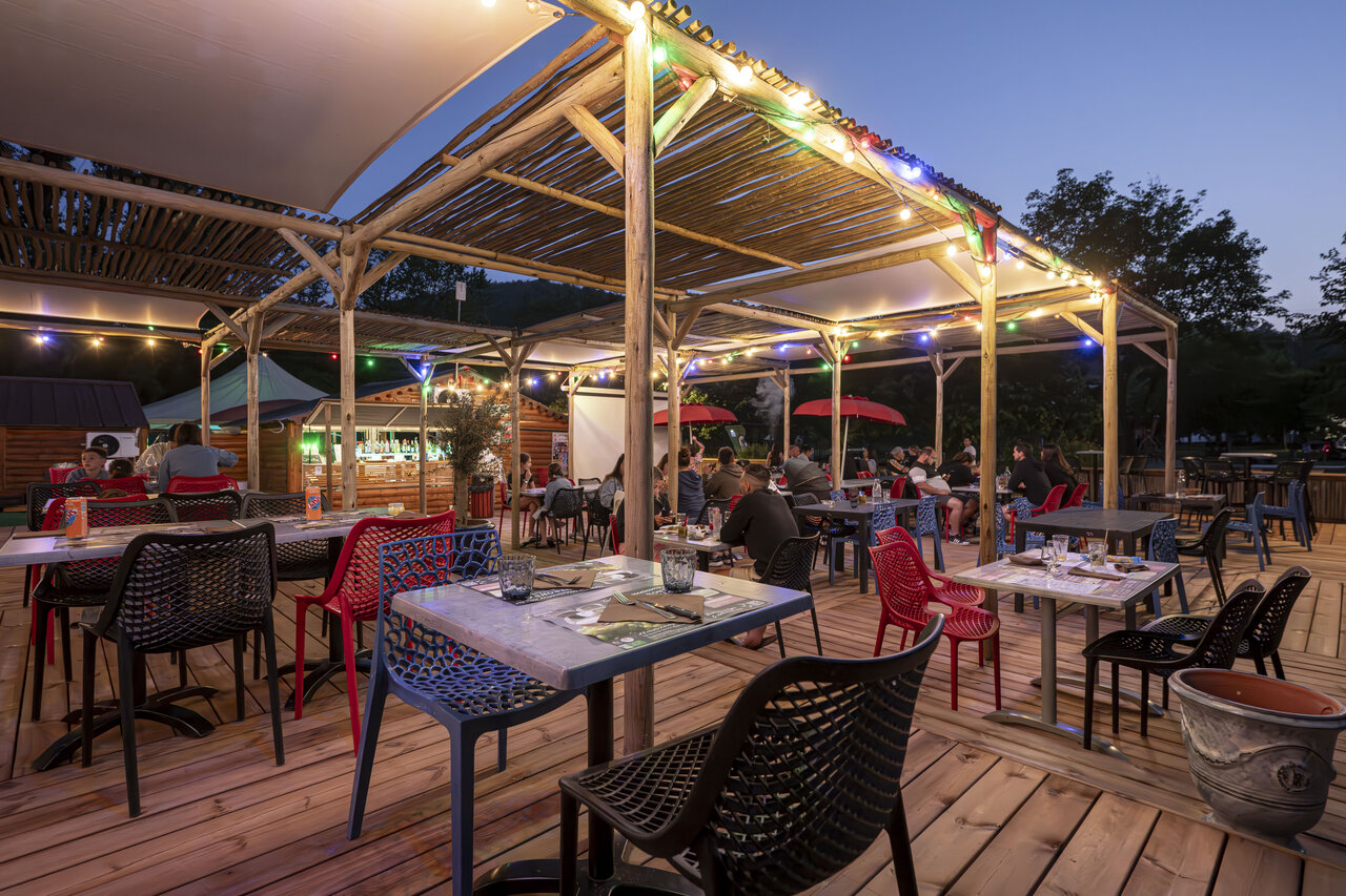 Terrasse restaurant et bar anim�e en soir�e au camping CLICOCHIC Filament � Thoiras (30).