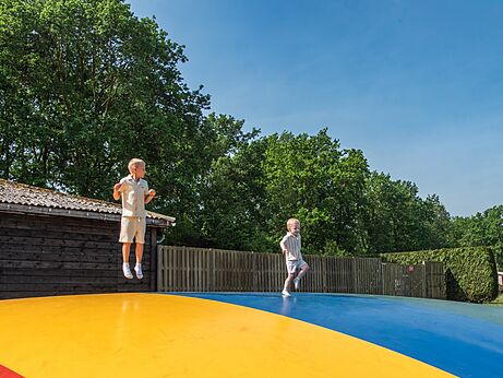 Children having fun on the jumping pillow at CAPFUN Fort Bedmar campsite in Sint-Gillis-Waas.