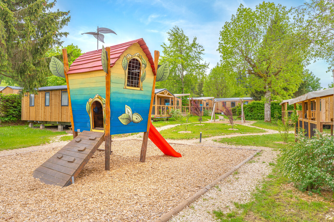 Playground with colorful playhouse and slide at CAPFUN Fuvettes in Malbuisson (25).