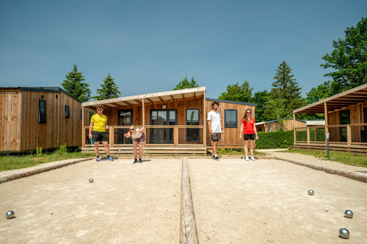 Petanque court with players and accommodations at CAPFUN Fuvettes campsite in Malbuisson (25).