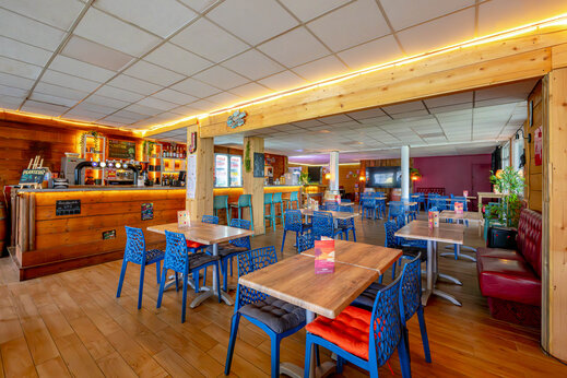 Bar und Restaurant mit Tischen auf dem Campingplatz CAPFUN Grand Large in FOUESNANT (29).