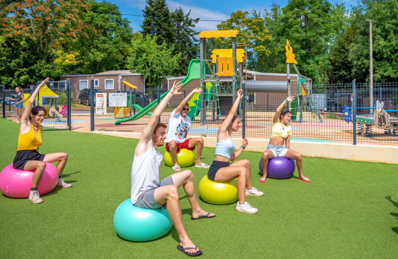 Fitness class on exercise balls, adults active at VAGUES OCEANES Granges campsite in GROLEJAC (24).