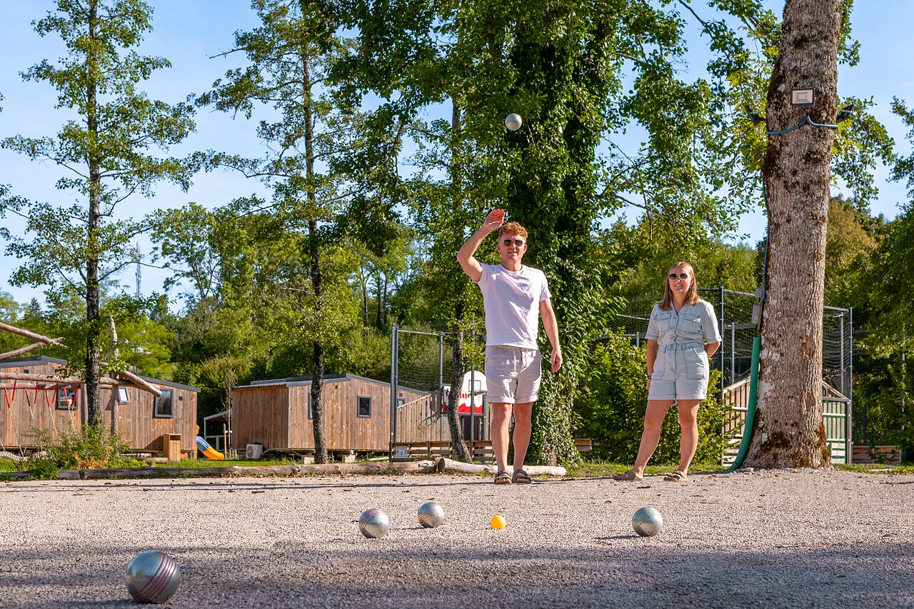 Lively p�tanque game with a couple at CLICOCHIC Grisi�re campsite.