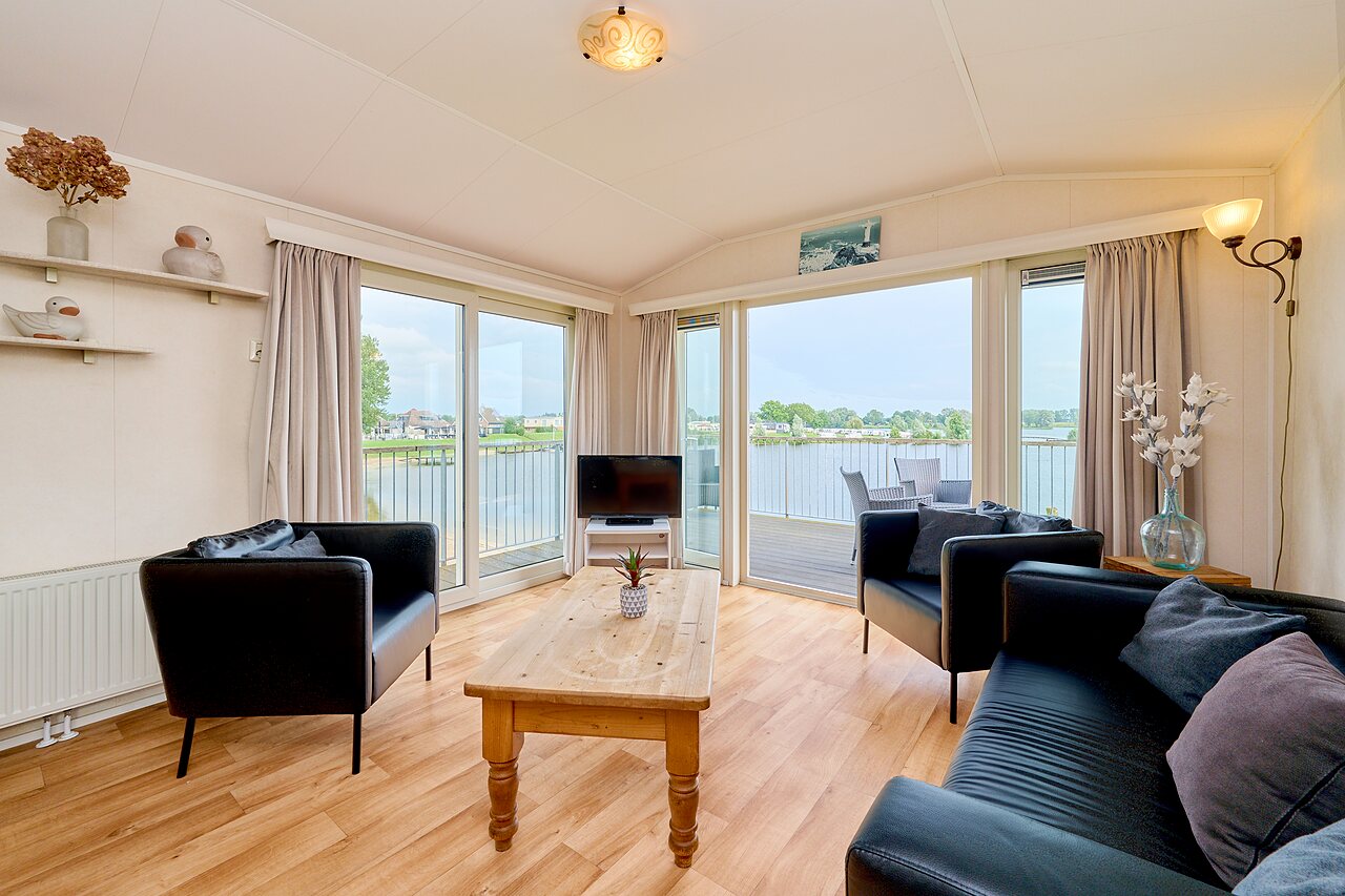 Helles Mobil-home Wohnzimmer, Blick auf Wasser auf dem Campingplatz CAPFUN Groene Eiland in Appeltern.