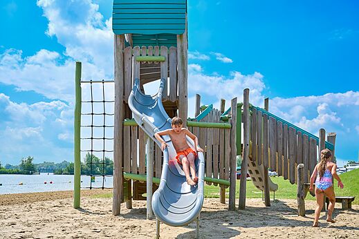 Speeltuin met glijbaan en zandstrand op camping CAPFUN Groene Eiland in Appeltern.
