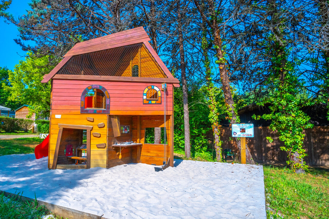 Wooden playhouse, sandbox at CAPFUN Hauts de Ratebout campsite in STE FOY DE BELVES (24).