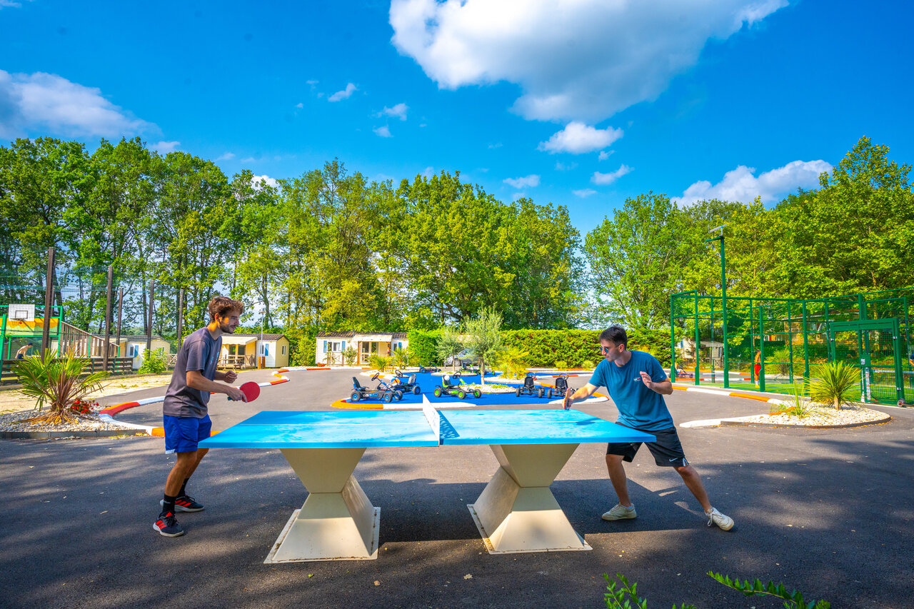Outdoor table tennis game, sports activities at CAPFUN Hauts de Ratebout campsite.