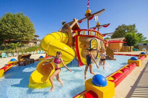 Spielbecken mit Rutsche und Piratenschiff auf dem Campingplatz CAPFUN Hauts de Ratebout in STE FOY DE BELVES (24).
