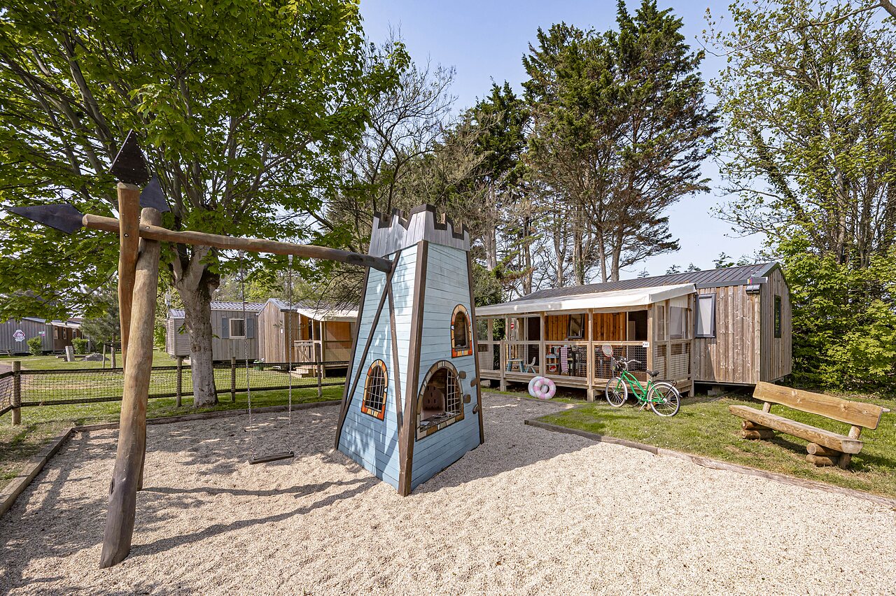 Kinderspielplatz mit Schloss und Schaukel, Mobilheime auf Camping CLICOCHIC Havre de Berni�res in Berni�res-sur-Mer (14).