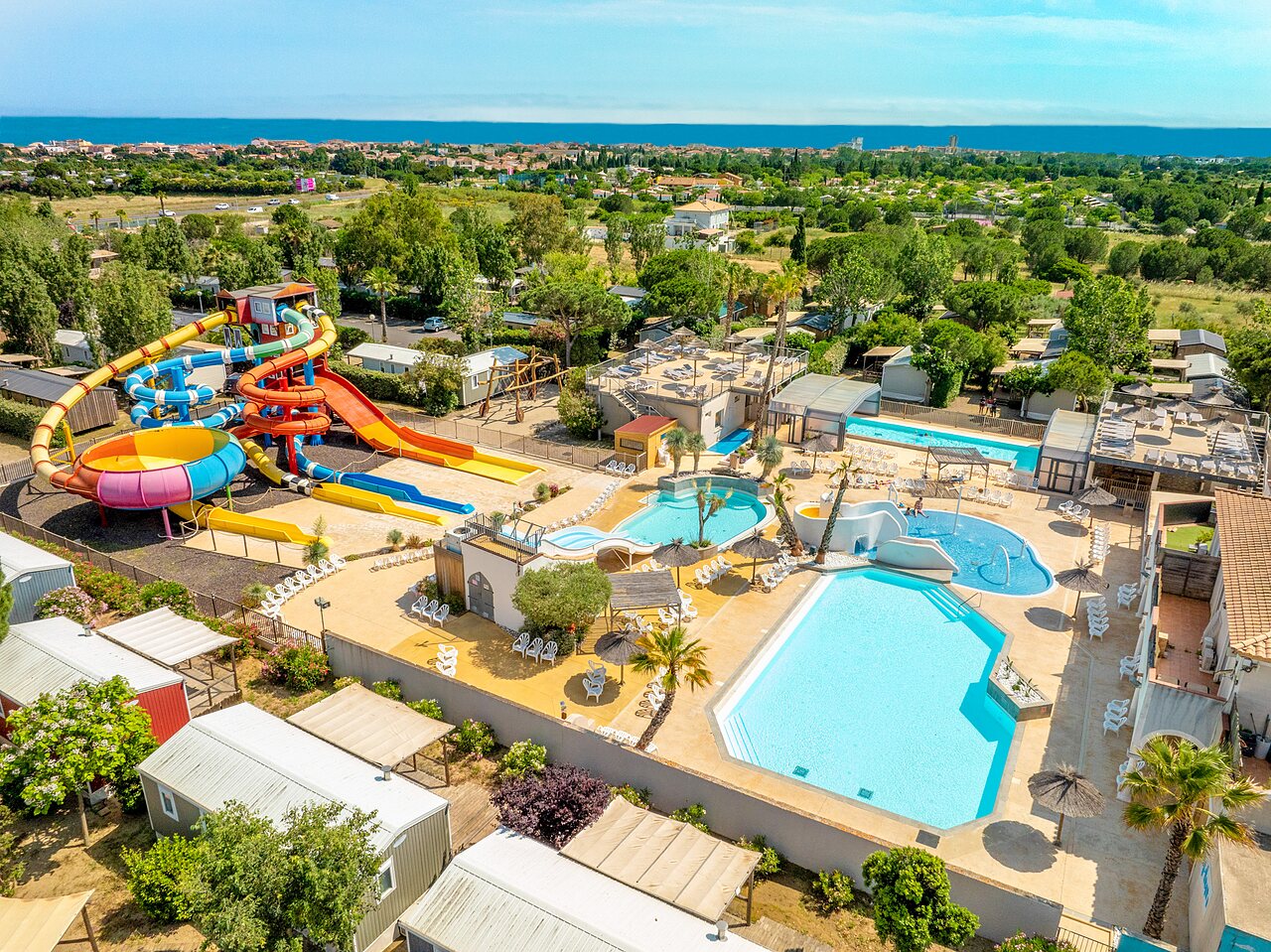 Giant water park, colorful slides and outdoor pools at CAPFUN Hermitage campsite in SERIGNAN (34).