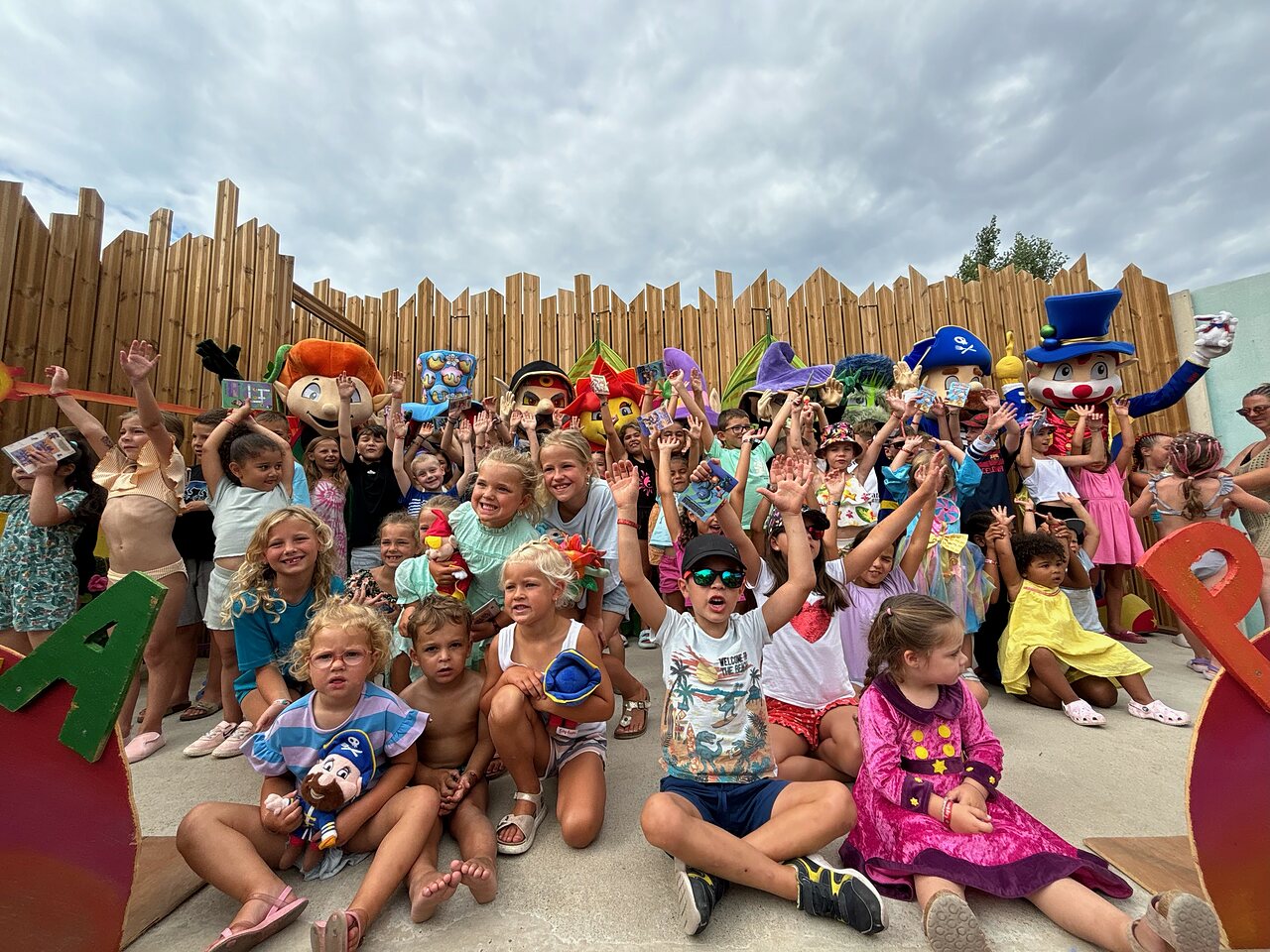 Happy children and mascots during entertainment at CAPFUN Hermitage campsite in SERIGNAN (34).
