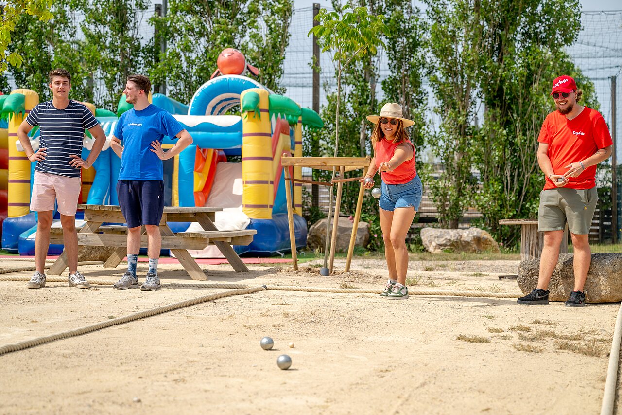 Petanque game and bouncy castle at CAPFUN Hermitage campsite in SERIGNAN (34).