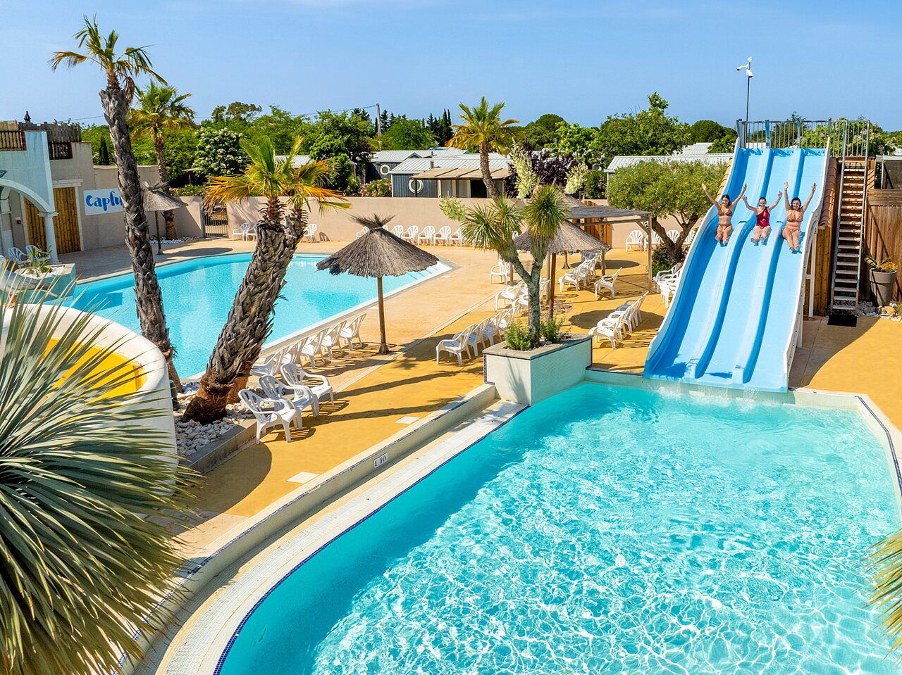 Water slide and outdoor swimming pools at CAPFUN Hermitage campsite in SERIGNAN (34).