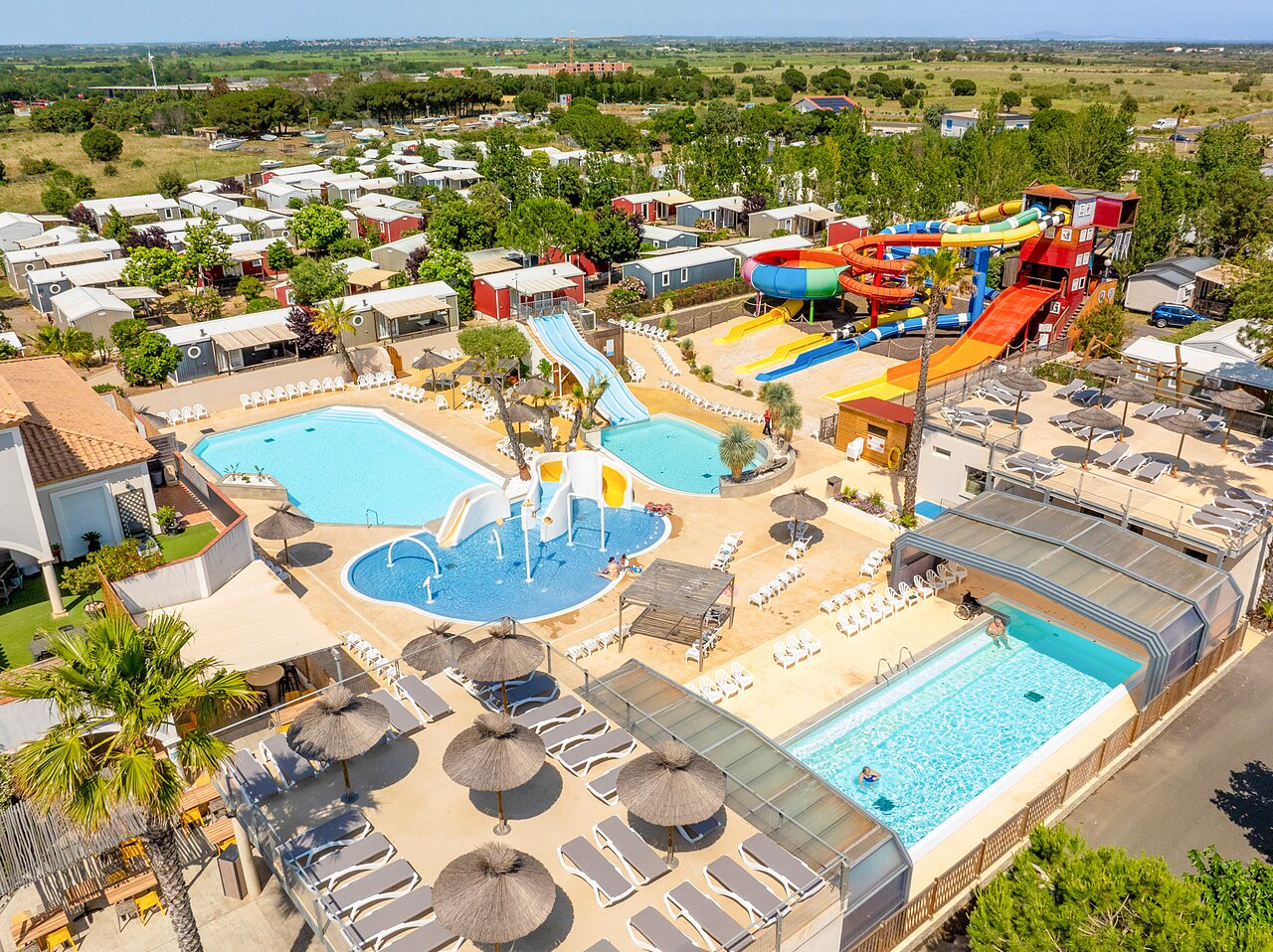Water park with giant slides, pools, and splash pad at CAPFUN Hermitage campsite in SERIGNAN (34).