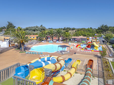 Colorful water slides, outdoor pool at CAPFUN Huttes campsite in Saint-Denis d'Oléron.