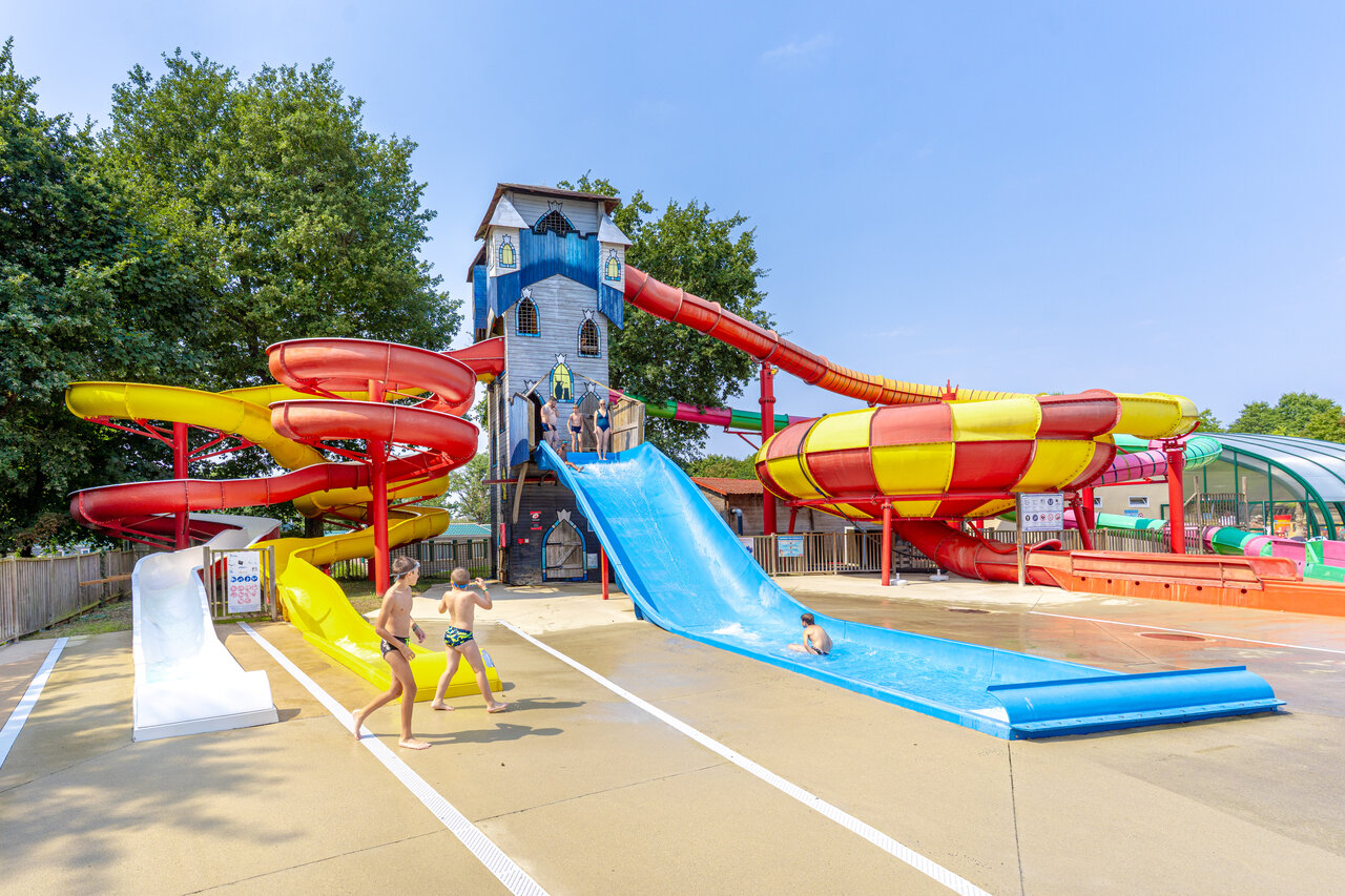 Wasserpark mit Riesenrutschen und Schlossturm auf dem Campingplatz CAPFUN Lac de Ribou in Cholet (49).