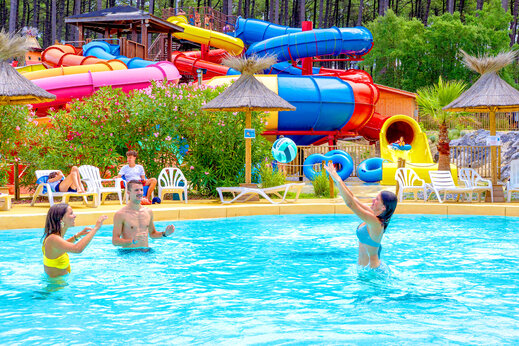 Bunte Wasserrutschen und belebtes Schwimmbad auf dem Campingplatz CAPFUN Landisland in Moliets-et-Maa (40).
