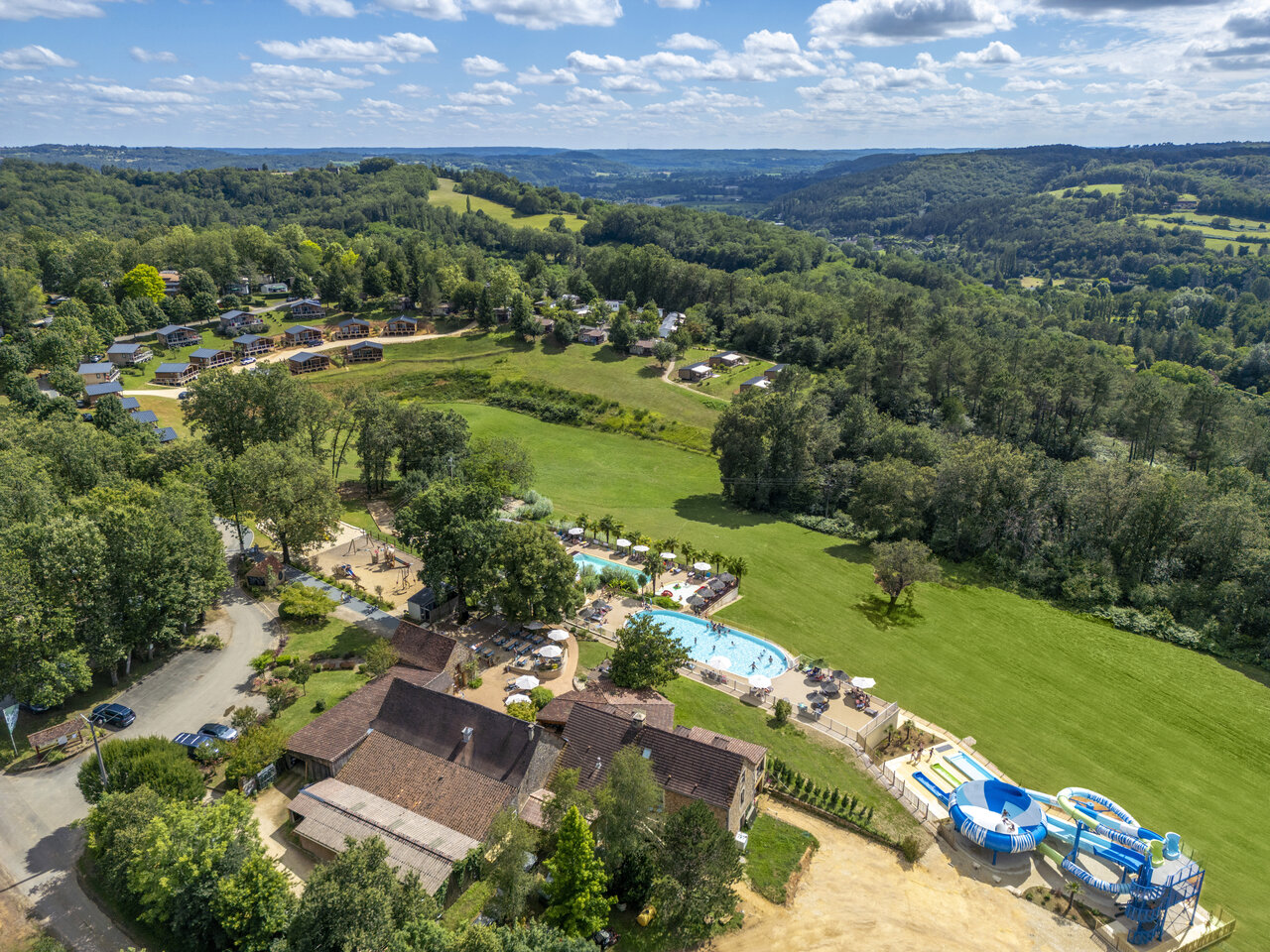 Aerial view of campsite with pool, slides and accommodations in Le Bugue (24).